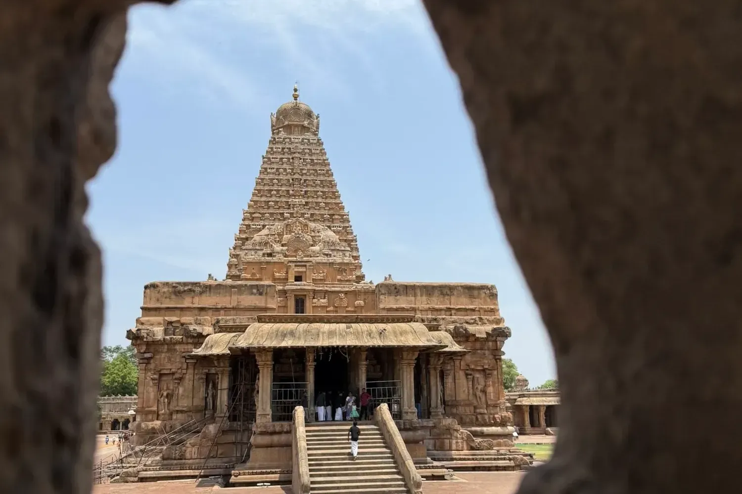 Brihadishvara Temple in Thanjavur seen through an opening in the stone wall
