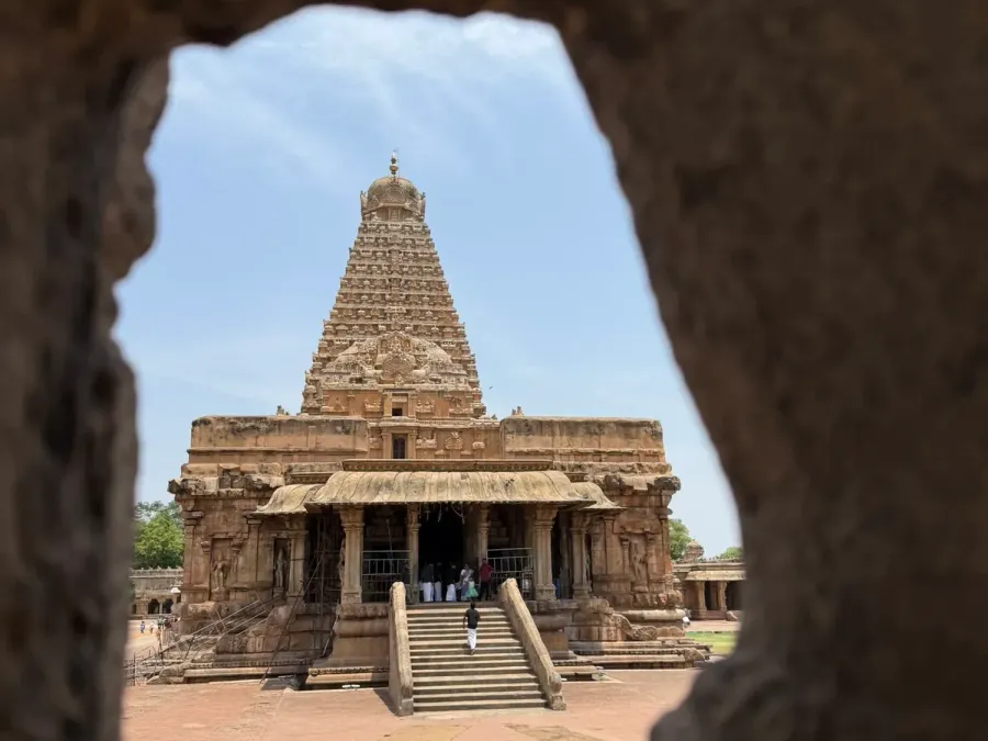 Brihadishvara Temple in Thanjavur seen through an opening in the stone wall