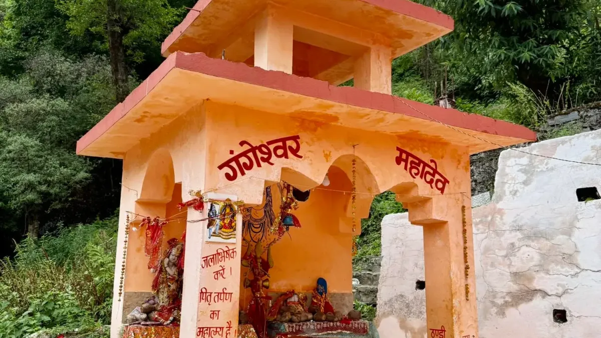Small orange roadside Shiva shrine among trees in the Bhagirathi valley