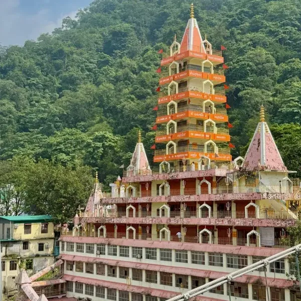 The thirteen-storey Trayambakeshwar temple in Rishikesh against a green hillside