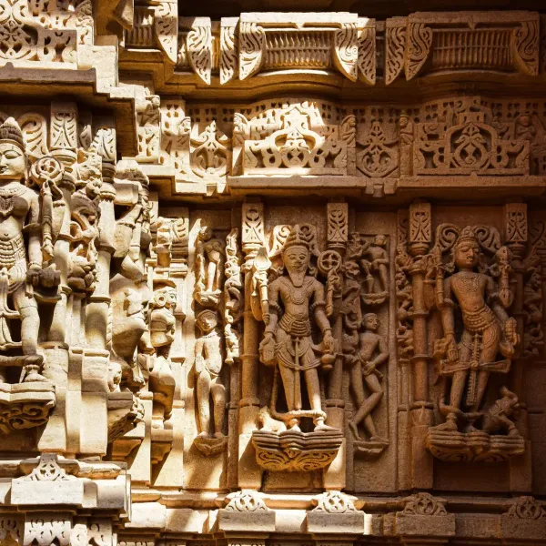 Carved sandstone deities on the wall of a Jain temple in Jaisalmer