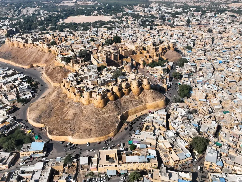Aerial view of Jaisalmer Fort rising above the sandstone houses of the old town