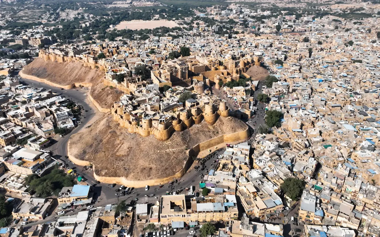 Aerial view of Jaisalmer Fort rising above the sandstone houses of the old town