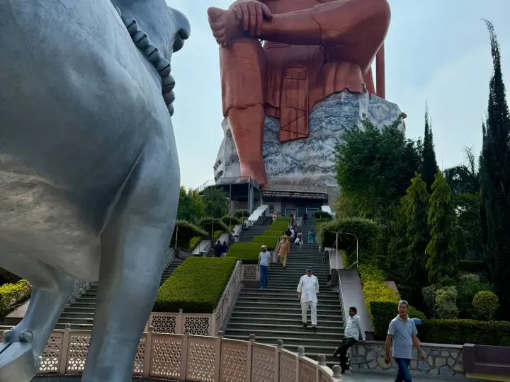 The seated Statue of Belief near Nathdwara with the Nandi bull in the foreground