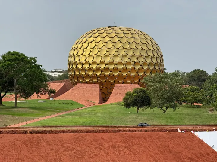 The golden sphere of the Matrimandir surrounded by gardens in Auroville